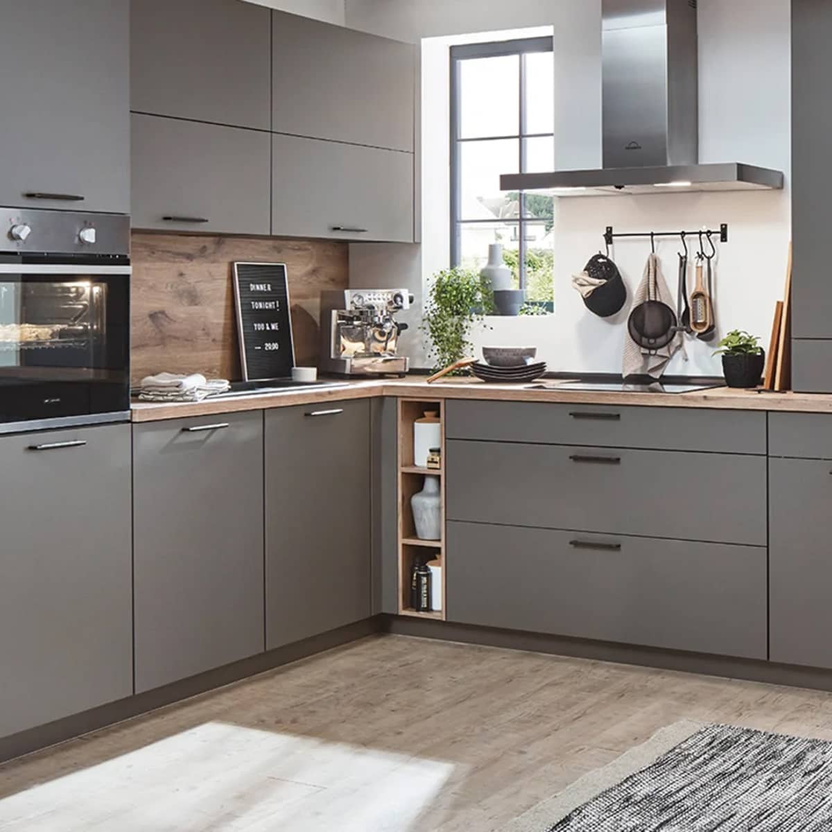 Touch Kitchen 344 Modern slate grey supermatt kitchen with TOUCH 344 handleless cabinets, light wood countertops, and urban stainless steel accents.
