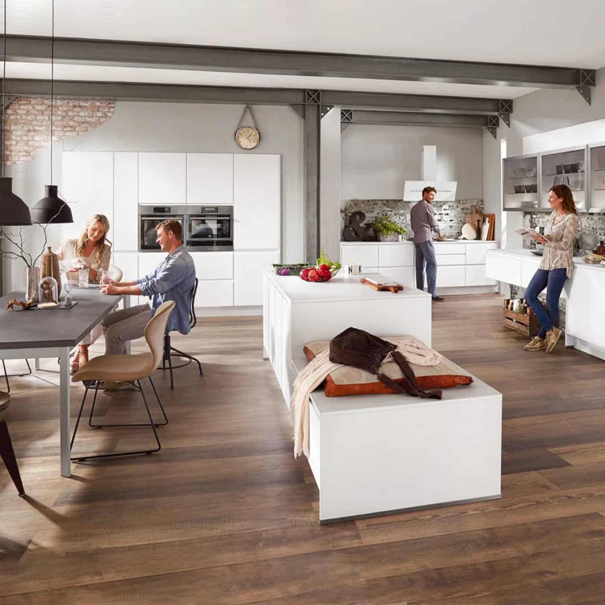 Nobilia Inline handleless kitchen featuring matte lacquer cabinetry, slate grey concrete island, and industrial brick niche.