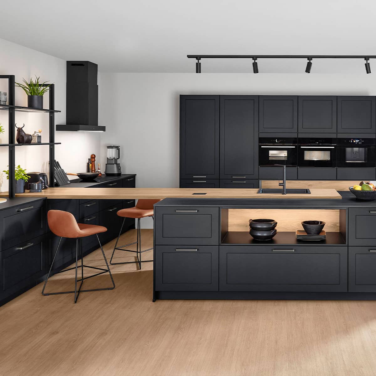 Spacious black matt kitchen with island, wood countertop, and open shelving.