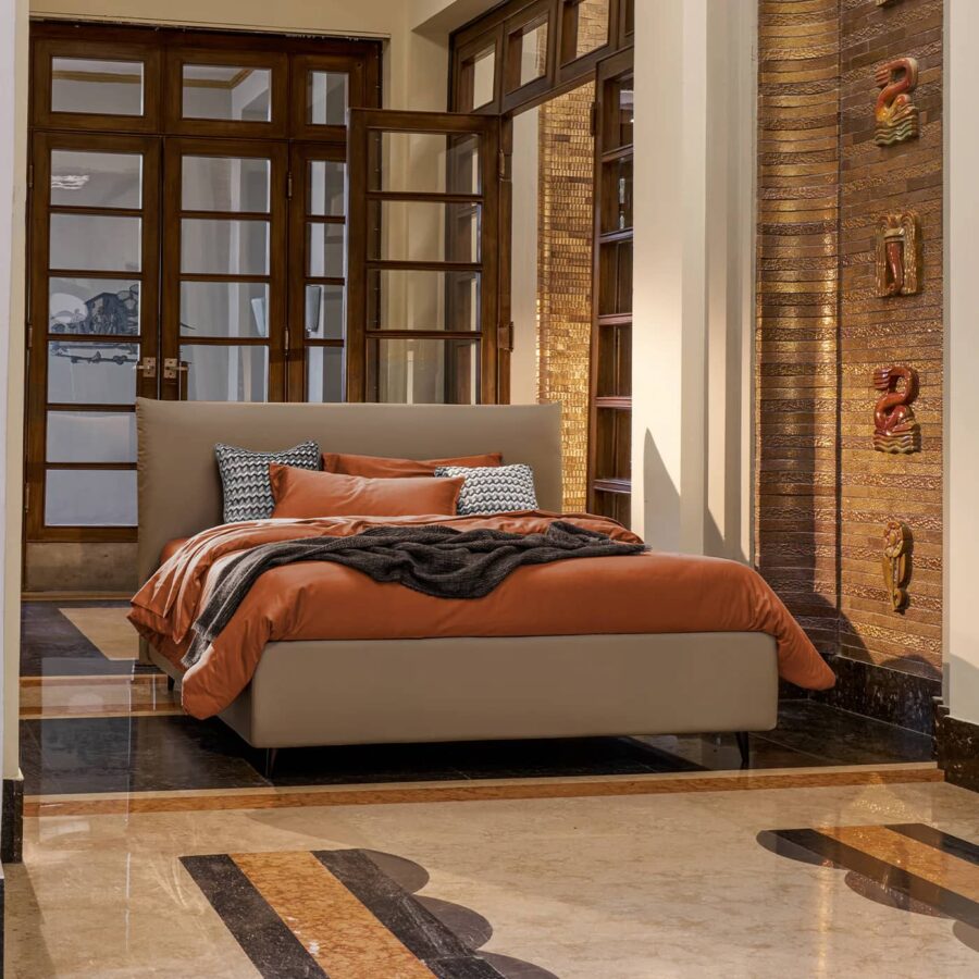 The Egon bed, a classic bed with a comfortable padded headboard.