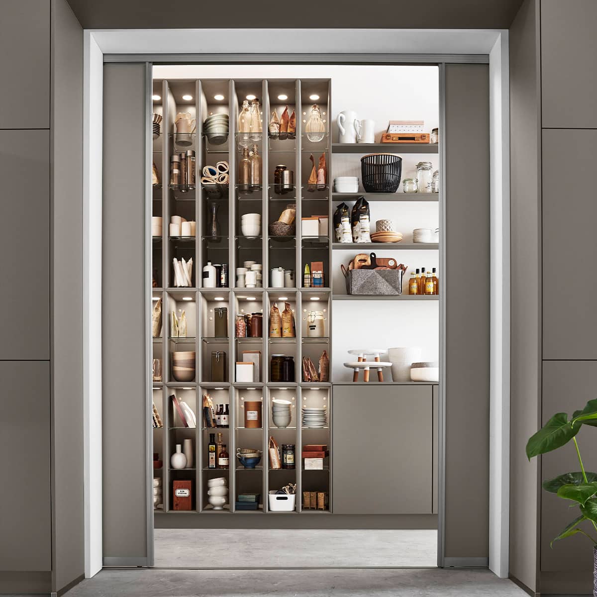 Easytouch 970 Taupe Kitchen with sliding doors leading to hidden pantry Taupe kitchen with sliding doors open to a well‑lit, organized pantry.