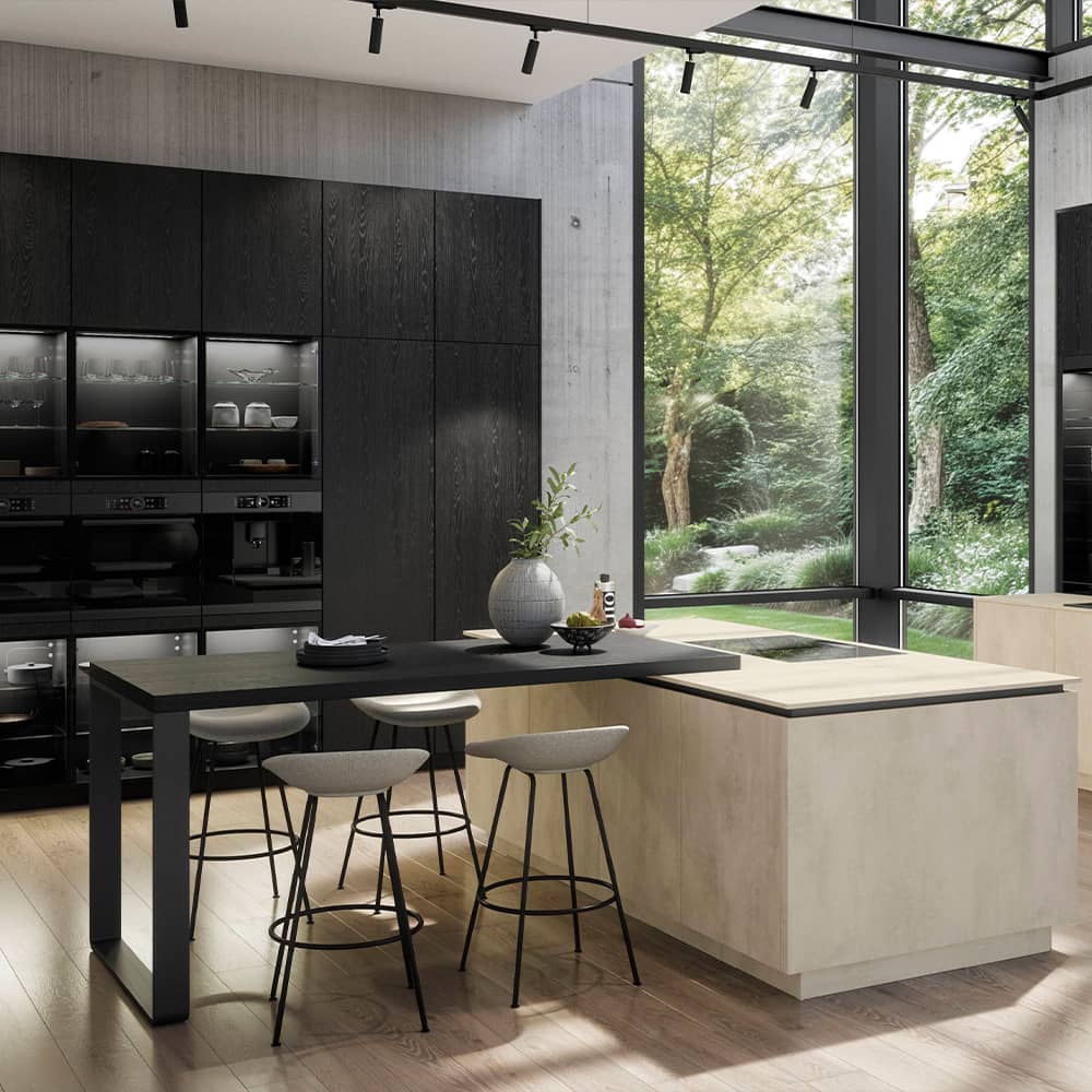 Sophisticated black wood-grain Riva tall units paired with a light stone island and integrated breakfast seating.