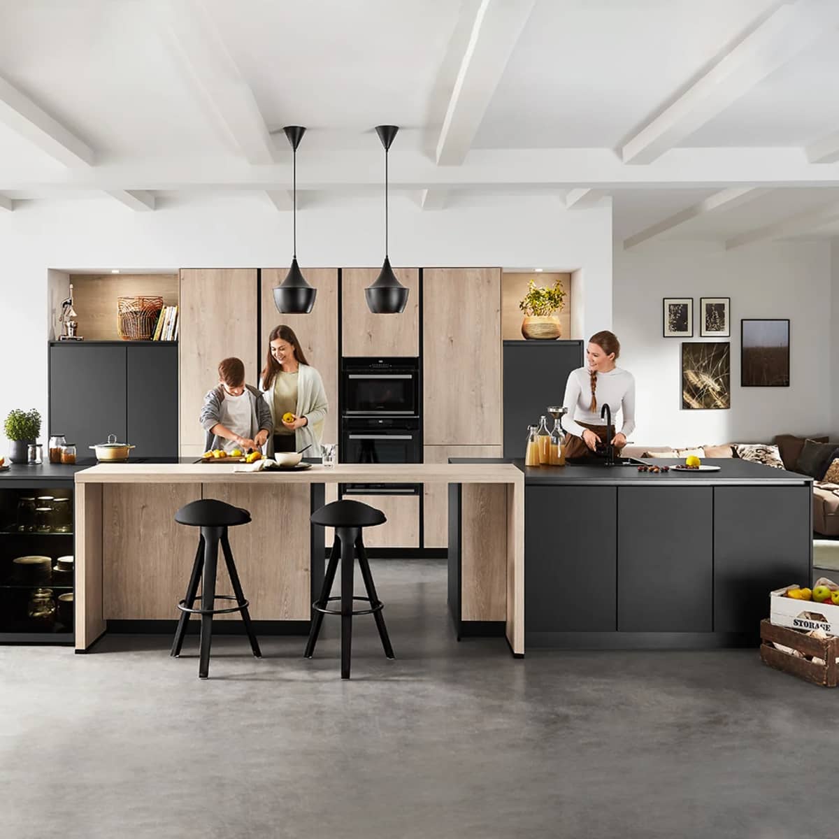 Open-plan 2026 nobilia Natura kitchen showing a family-friendly layout with matte black cabinetry, authentic oak-look tall units, and a large central island.