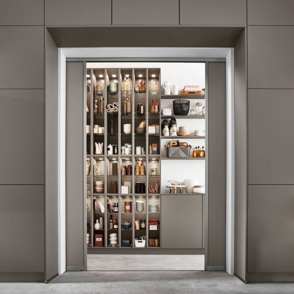 Pantry room behind seamless kitchen doors.
