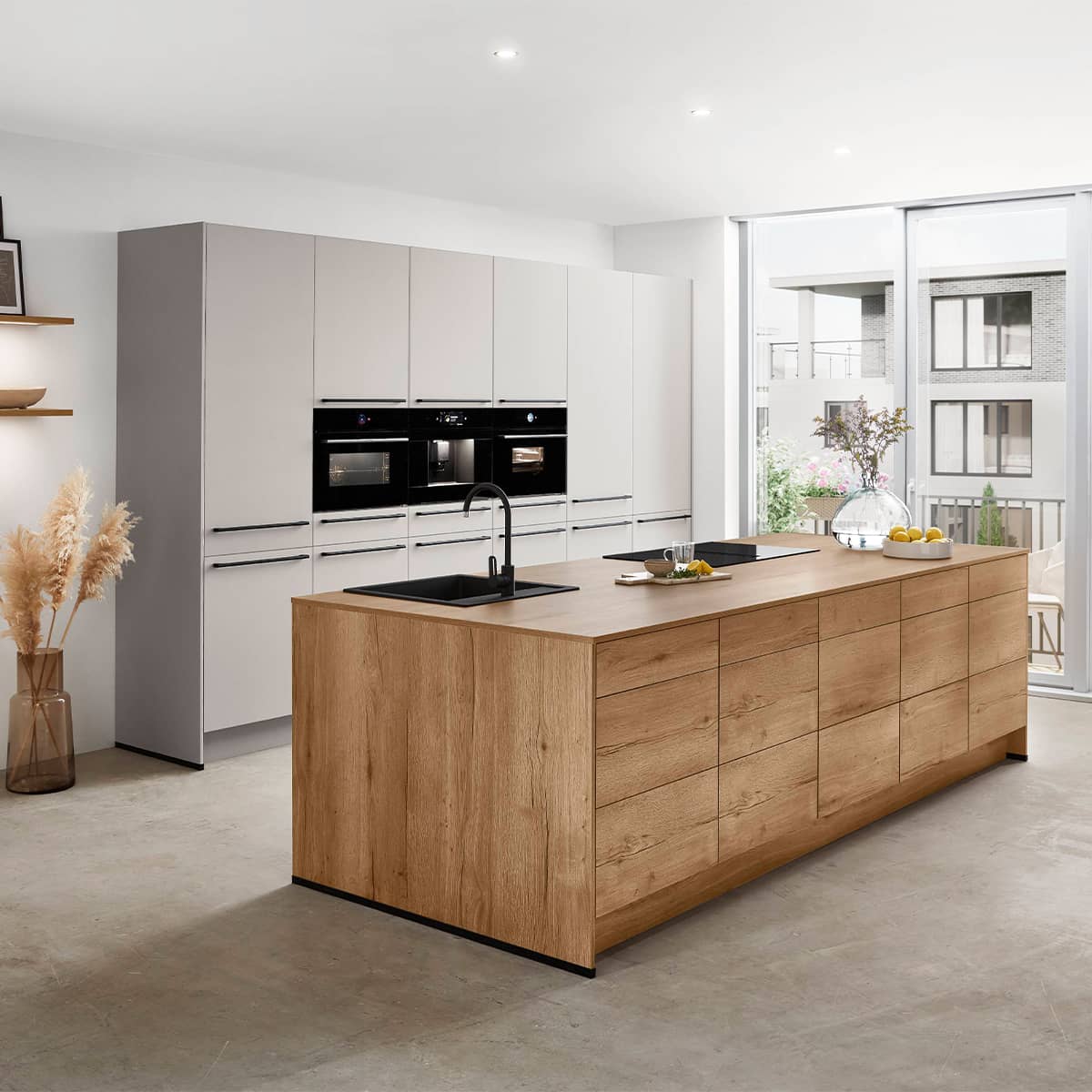 Contemporary Nobilia Softline 508 kitchen with light cabinets, wood‑effect island and integrated appliances in a large open space.