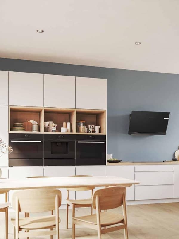 Modern kitchen featuring black Bosch appliances: oven, built-in coffee machine, and compact oven seamlessly integrated into cabinetry.