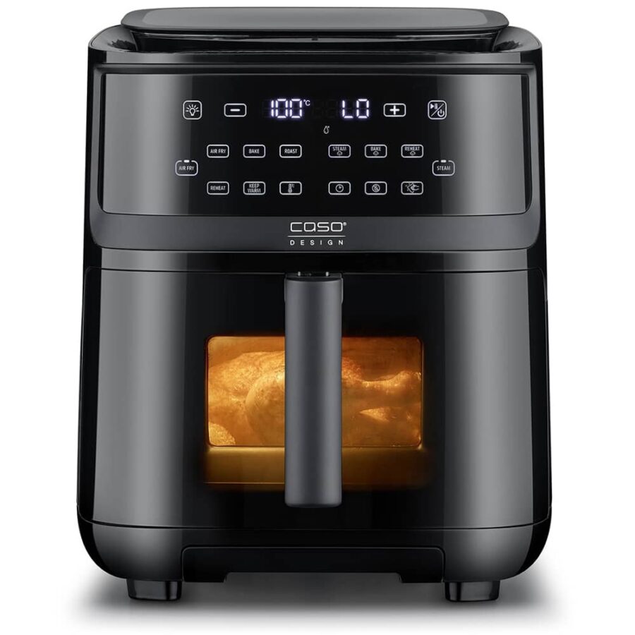 Air Fryer Steam 700 frontal view on white background, interior light on showing whole chicken cooking inside.