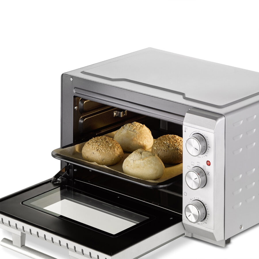CASO TO 20 Electronic Oven with open door, baking tray holding buns on a baking sheet inside.