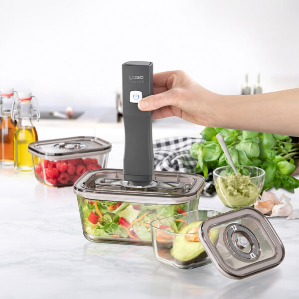 Caso Hand-held Vacuum Sealer sealing a lunch box filled with salad