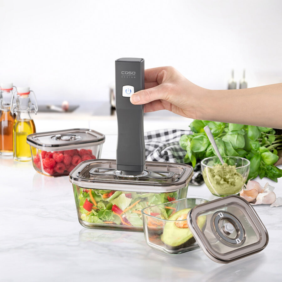 Caso Hand-held Vacuum Sealer sealing a lunch box filled with salad