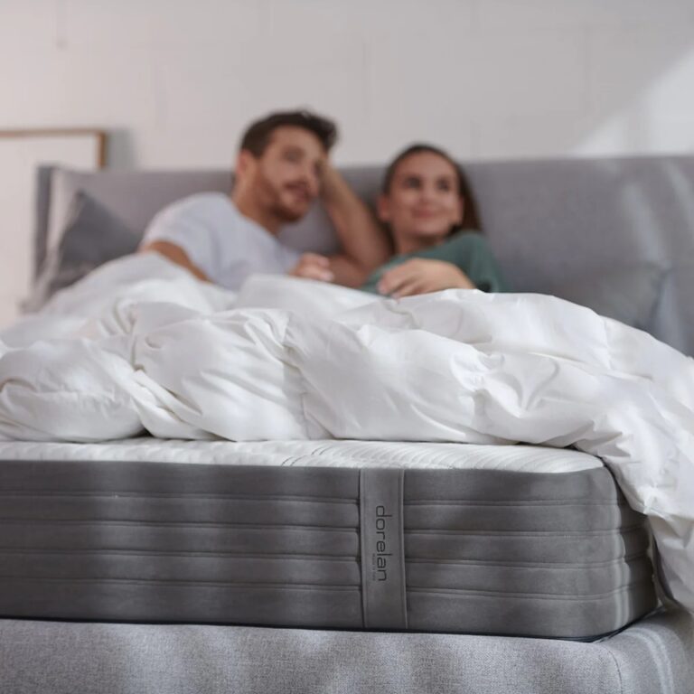 Couple resting on a Dorelan bed and mattress.