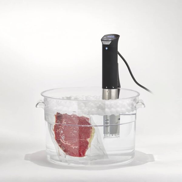 CASO Sous Vide Stick with WiFi control submerged in water with vacuum packed beef.