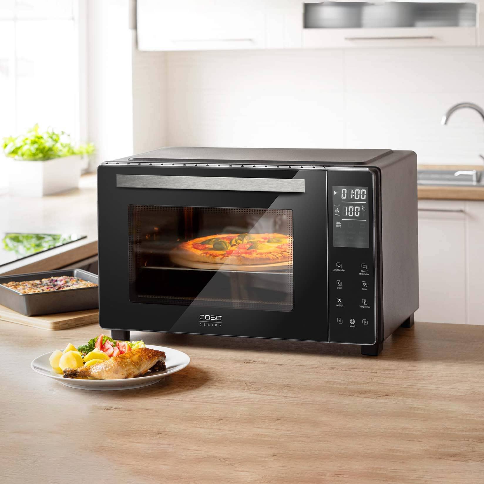 Caso Table oven with pizza being cooked inside