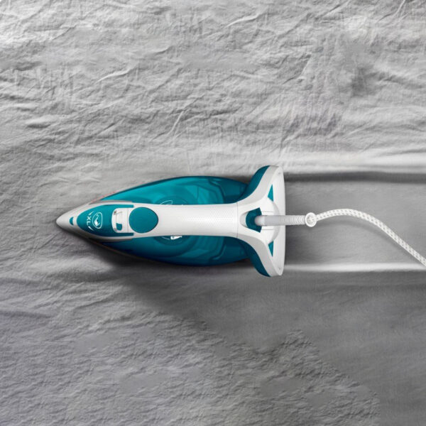 Steam Iron, ironing a grey fabric