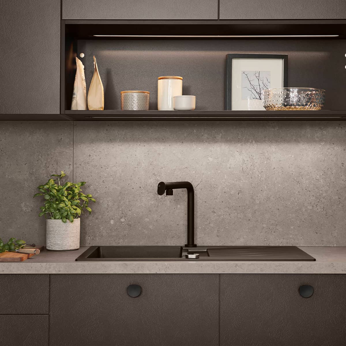 Close-up of Nobilia Look 605 Coffee kitchen featuring a black matte sink, minimalist tap, and integrated shelf lighting.